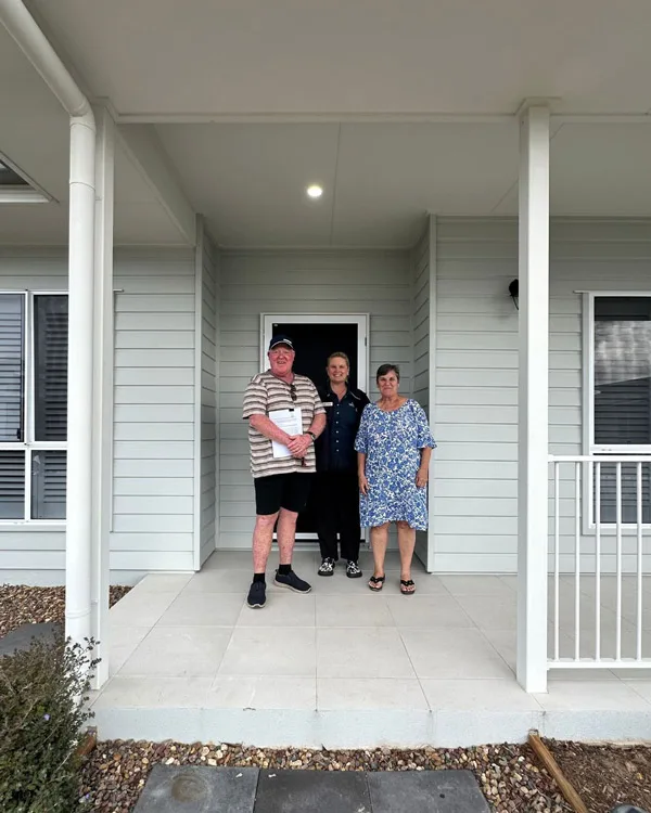 Residents Ron and Marion on the veranda of their new Good Life home
