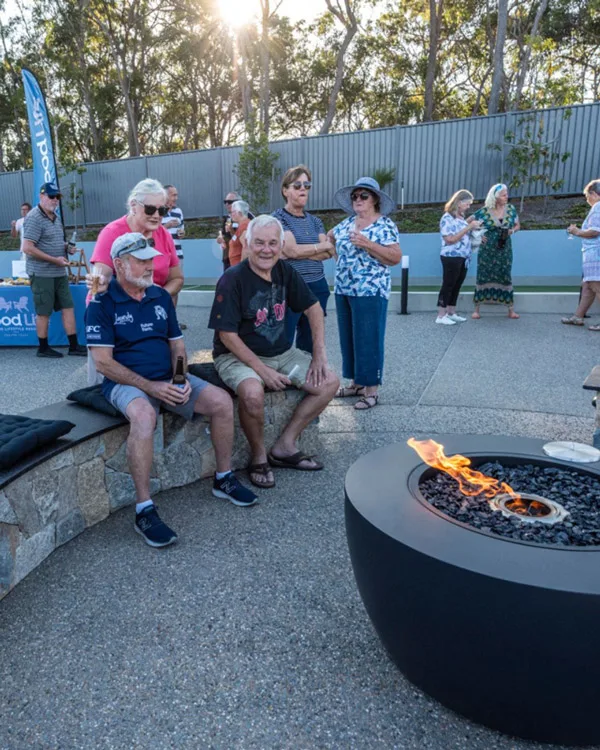 Residents celebrate around the fire pit, with the completion of The Clubhouse and its facilities