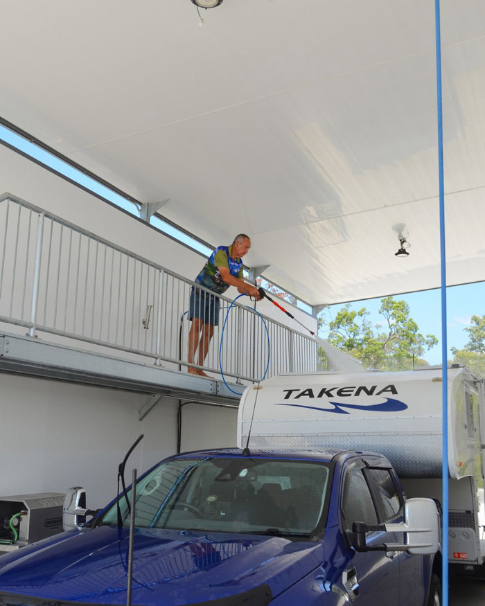 Home Owner using the RV Wash Bay at Good Life Fraser Coast to clean a motorhome.